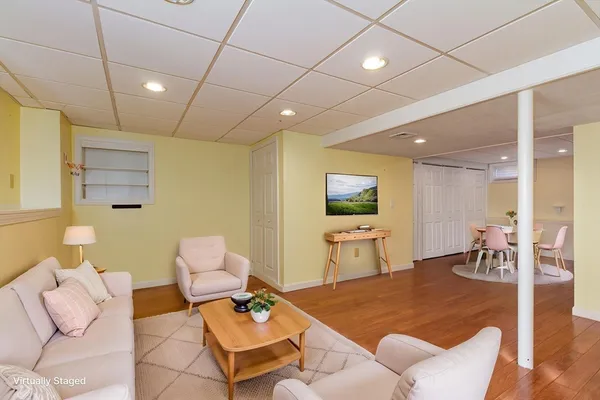 a living room with furniture and wooden floor