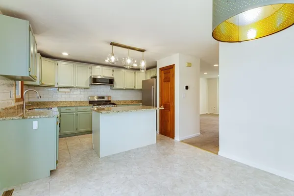 a kitchen with a sink cabinets and window