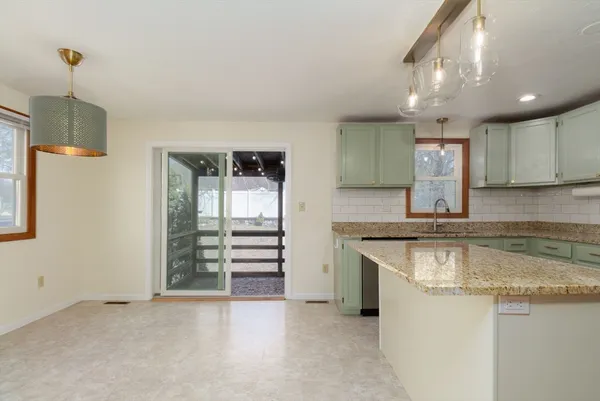 a kitchen with granite countertop a sink and a stove top oven