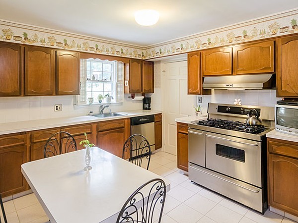 25 Wauwinet Road Newton, MA 02465 - Photo 7 of 25 a kitchen with stainless steel appliances granite countertop a sink stove and refrigerator