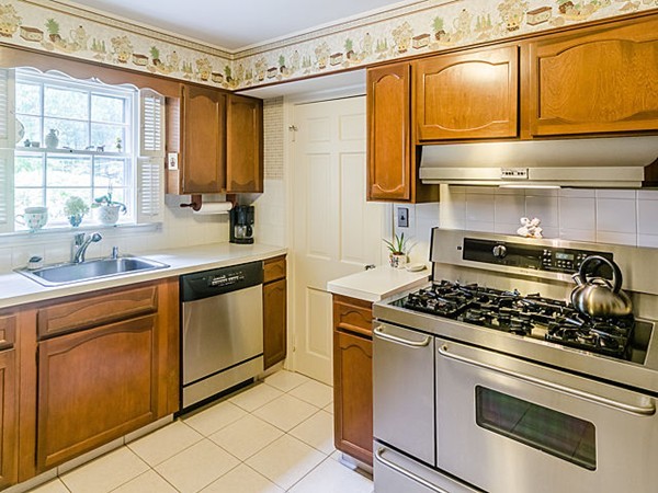 25 Wauwinet Road Newton, MA 02465 - Photo 8 of 25 a kitchen with stainless steel appliances granite countertop a stove and a sink