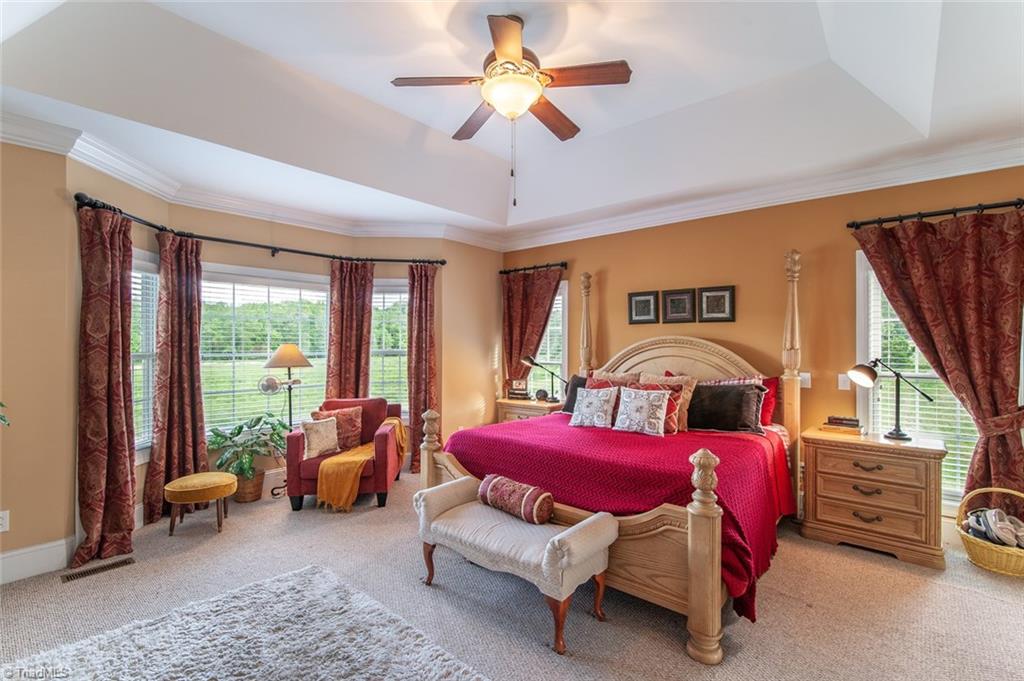 5802 Crutchfield Farm Road Oak Ridge, NC 27310 - Photo 22 of 30 Main level Master bedroom with private backyard views, plenty of sitting room