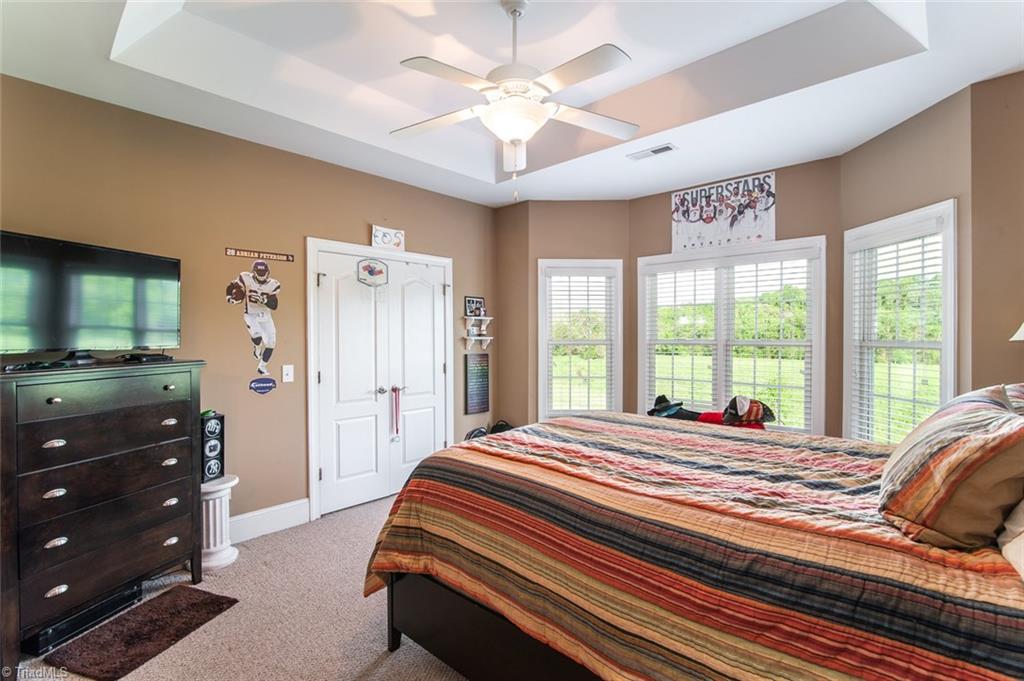 5802 Crutchfield Farm Road Oak Ridge, NC 27310 - Photo 26 of 30 This bedroom has its own private bath, has stunning backyard views.