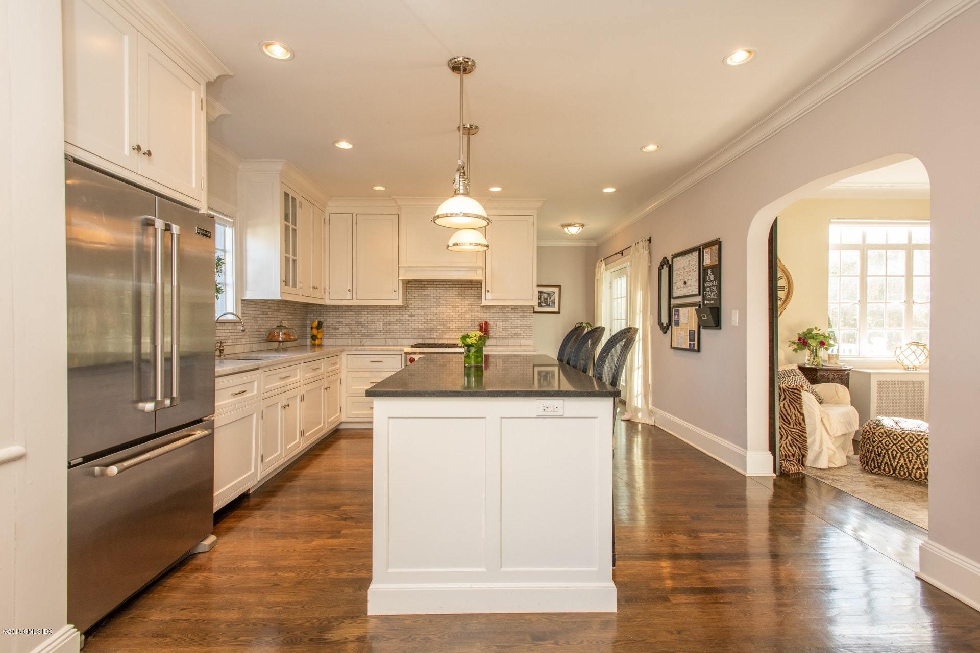 34 Crescent Road Riverside, CT 06878 - Photo 11 of 37 a kitchen with stainless steel appliances granite countertop a refrigerator a oven a sink and white cabinets with wooden floor