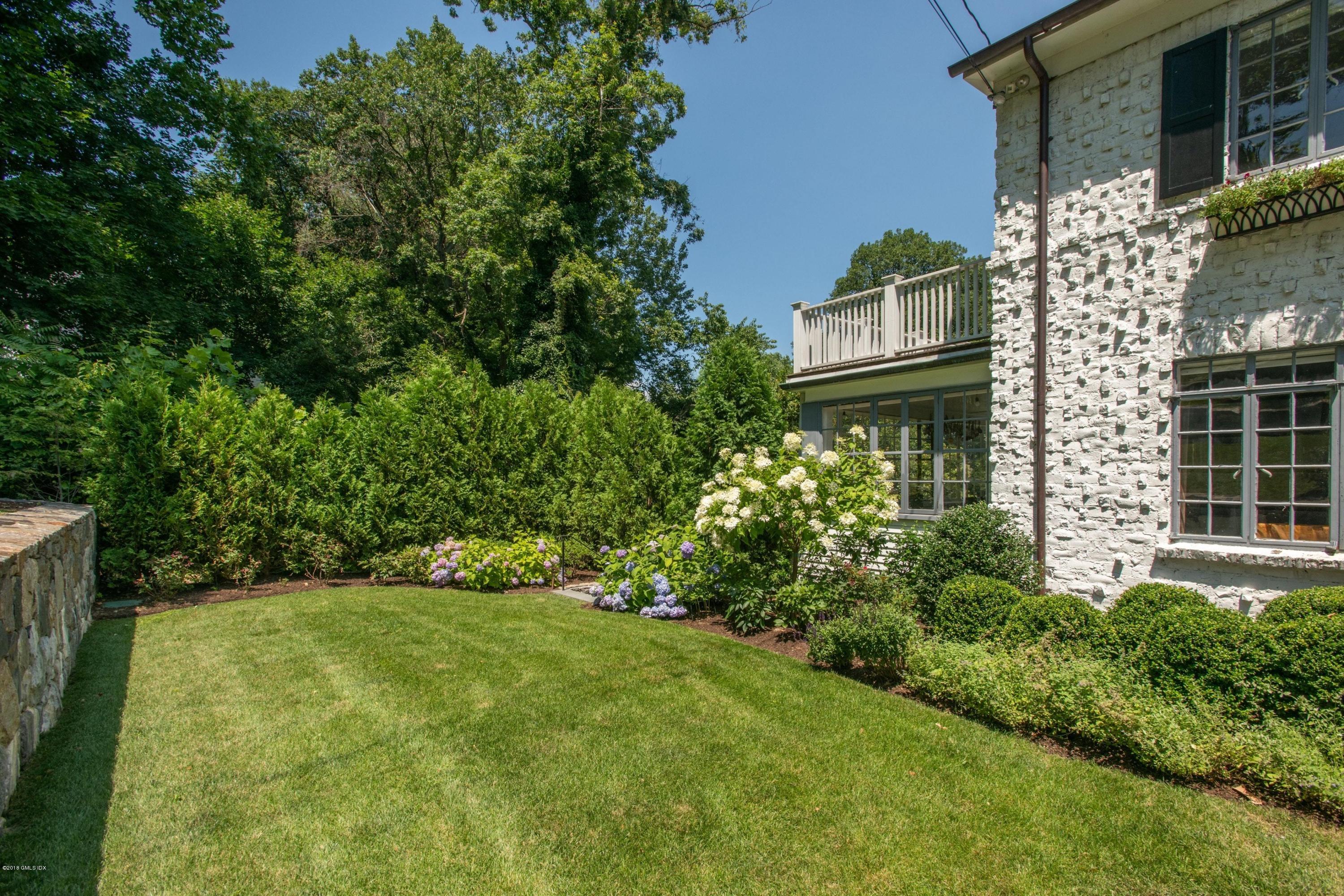 34 Crescent Road Riverside, CT 06878 - Photo 26 of 37 a view of a backyard with plants and large trees