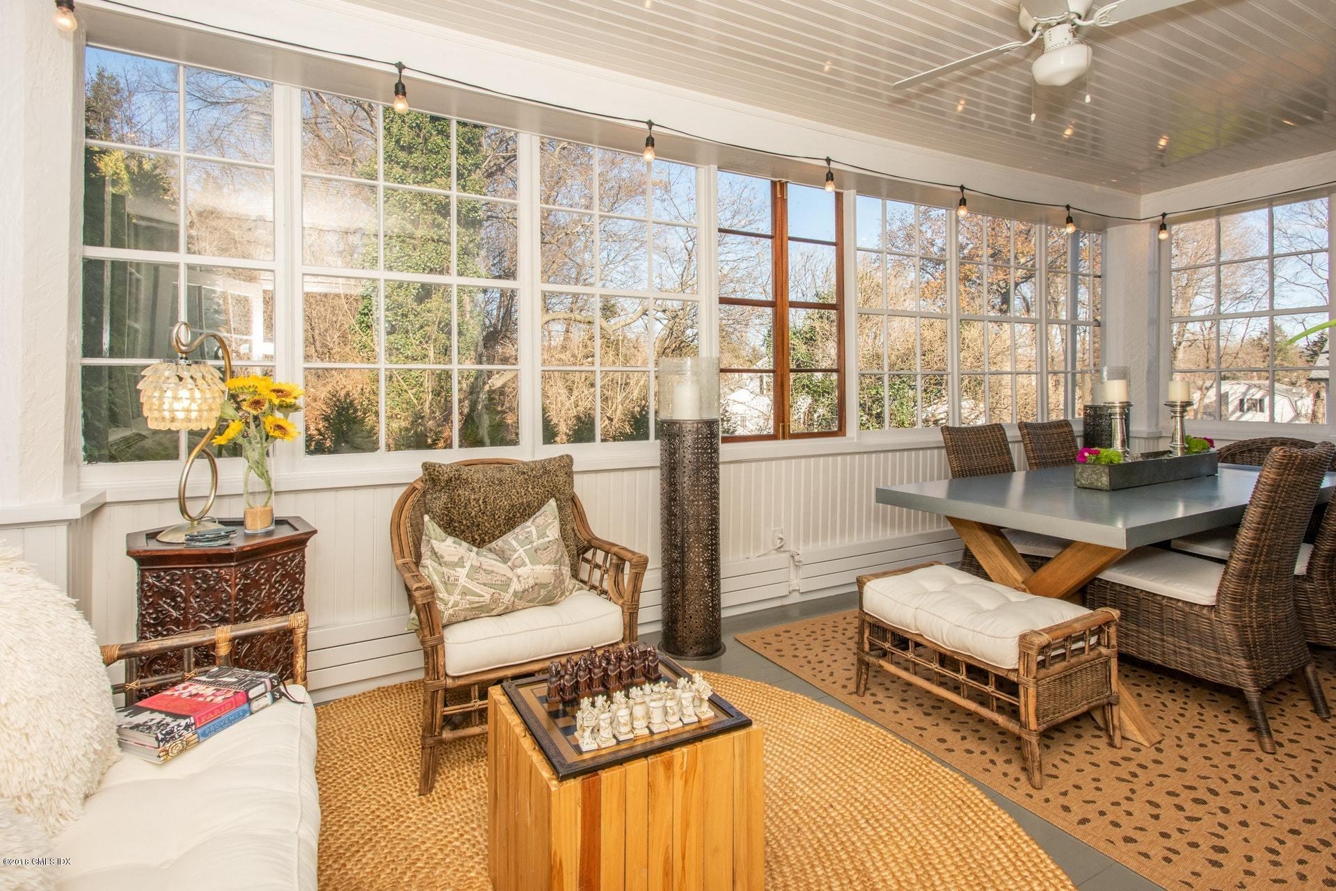 34 Crescent Road Riverside, CT 06878 - Photo 6 of 37 a living room with furniture and a floor to ceiling window