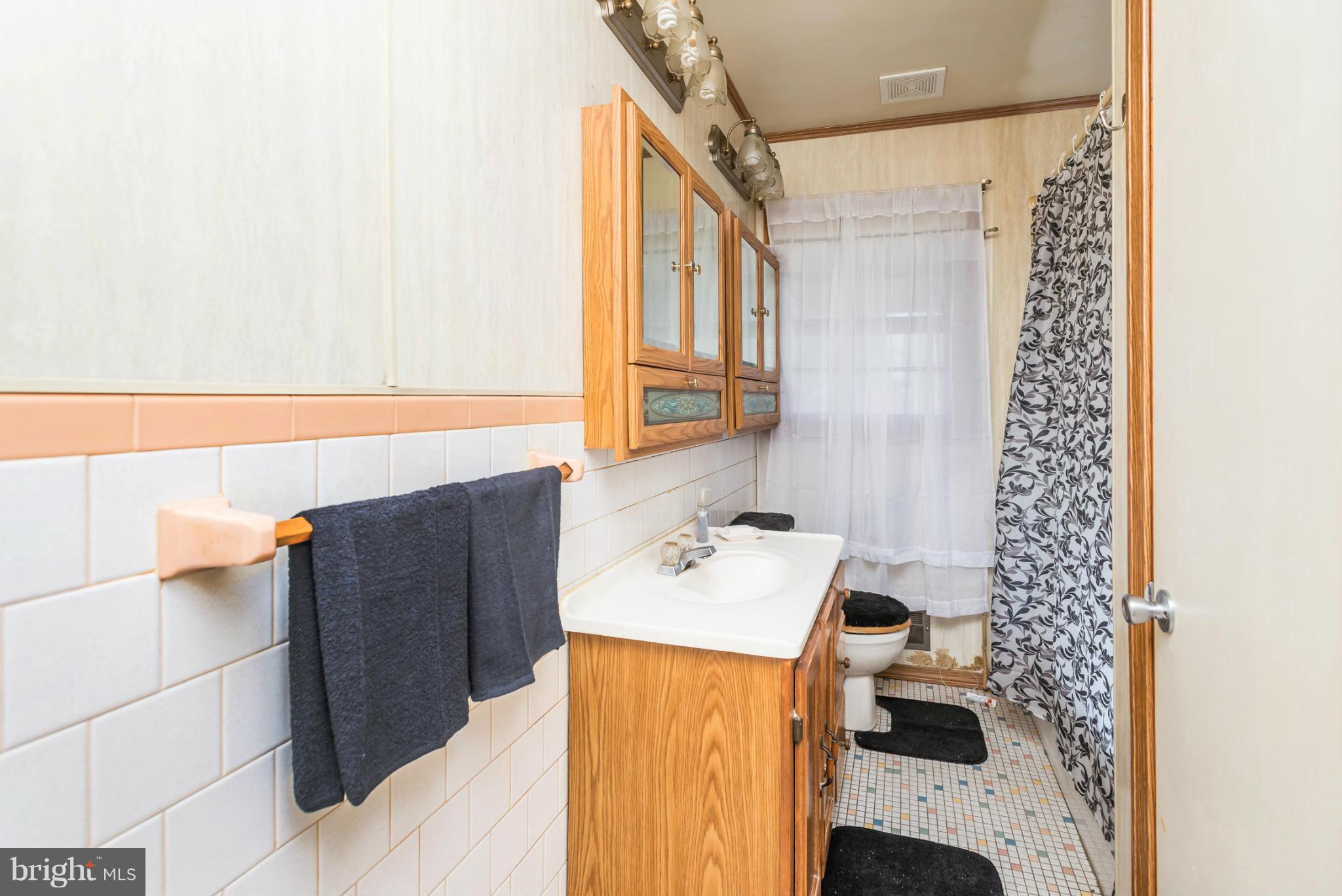 46 Carroll Road Pasadena, MD 21122 - Photo 11 of 18 a bathroom with a sink and a mirror