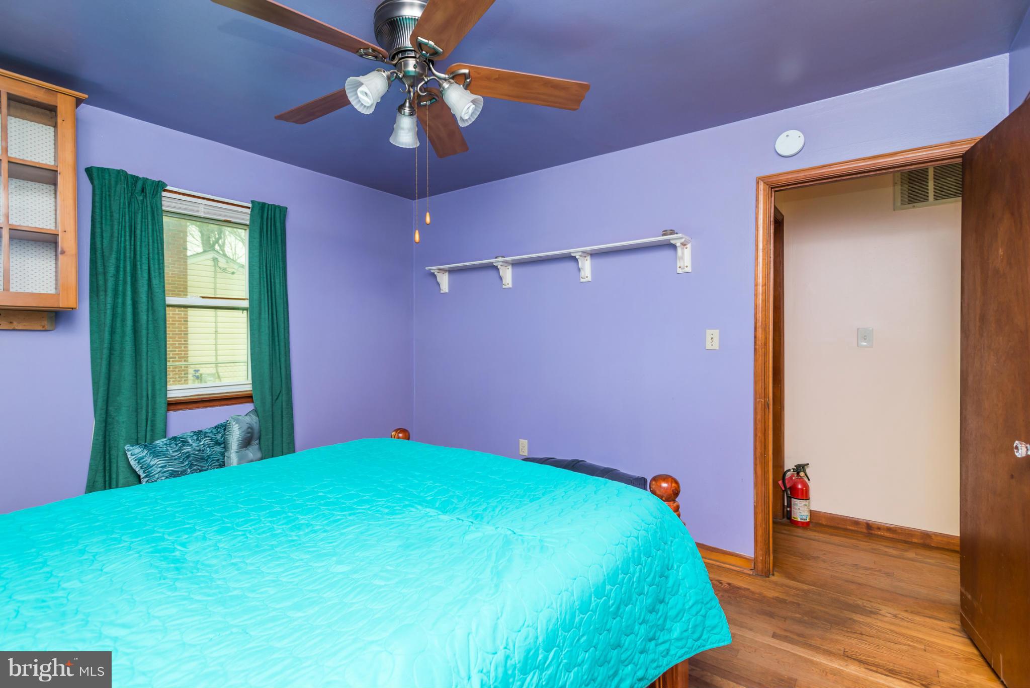 46 Carroll Road Pasadena, MD 21122 - Photo 13 of 18 a bedroom with a bed and a chandelier