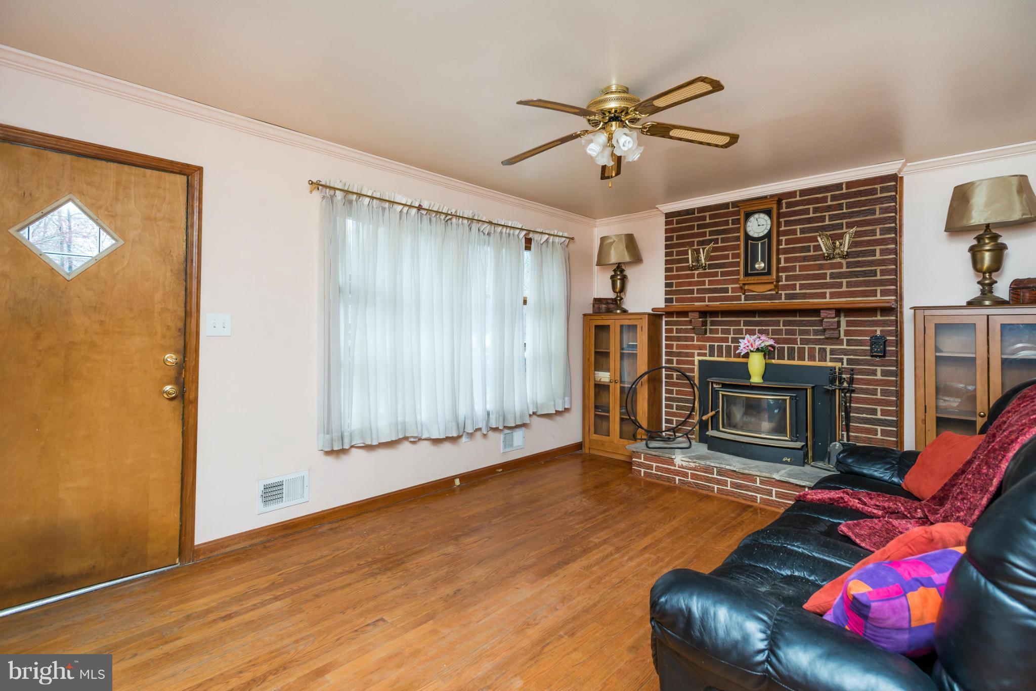 46 Carroll Road Pasadena, MD 21122 - Photo 3 of 18 a living room with furniture and a fireplace