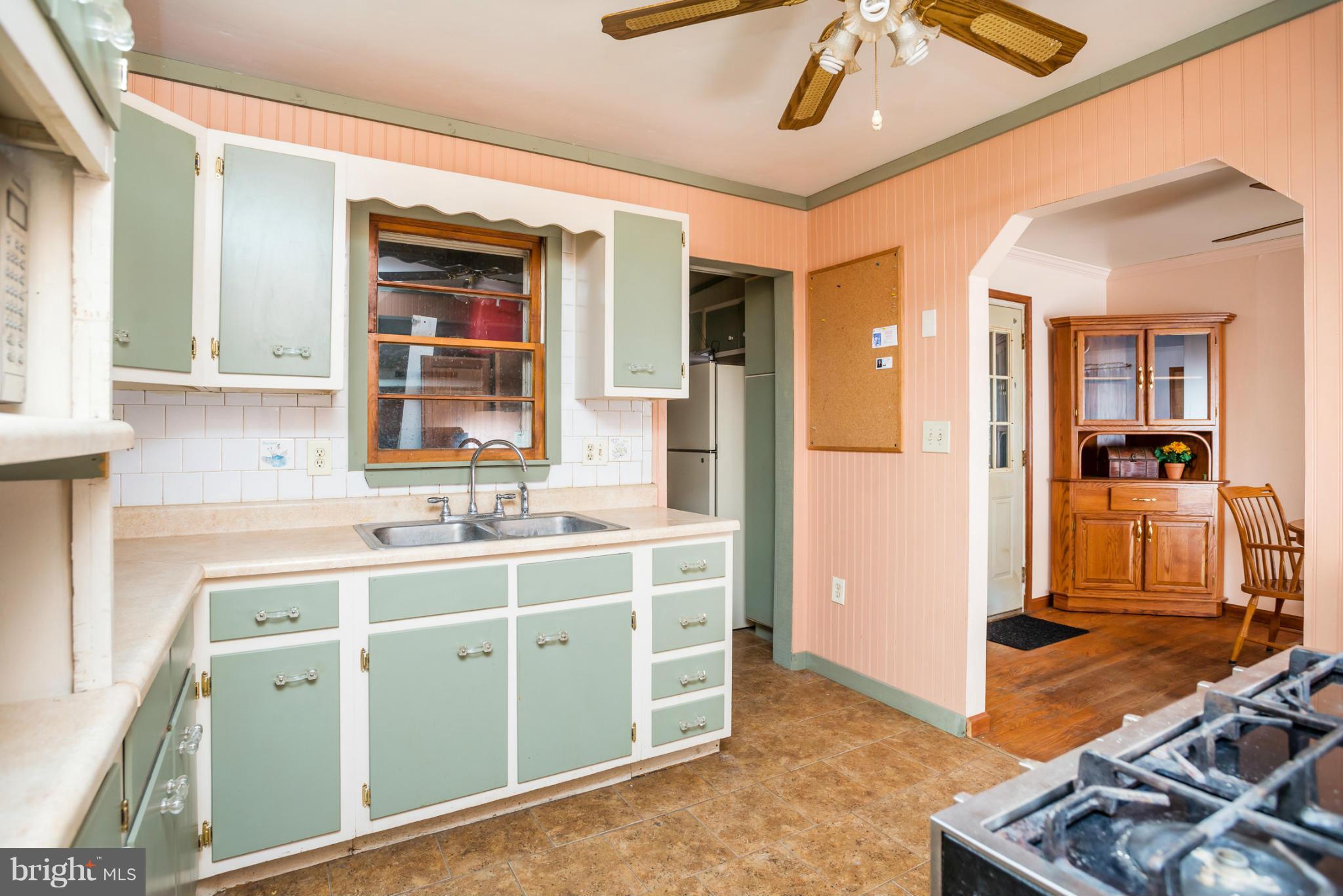 46 Carroll Road Pasadena, MD 21122 - Photo 7 of 18 a view of a kitchen with kitchen island granite countertop a sink and a stove top oven