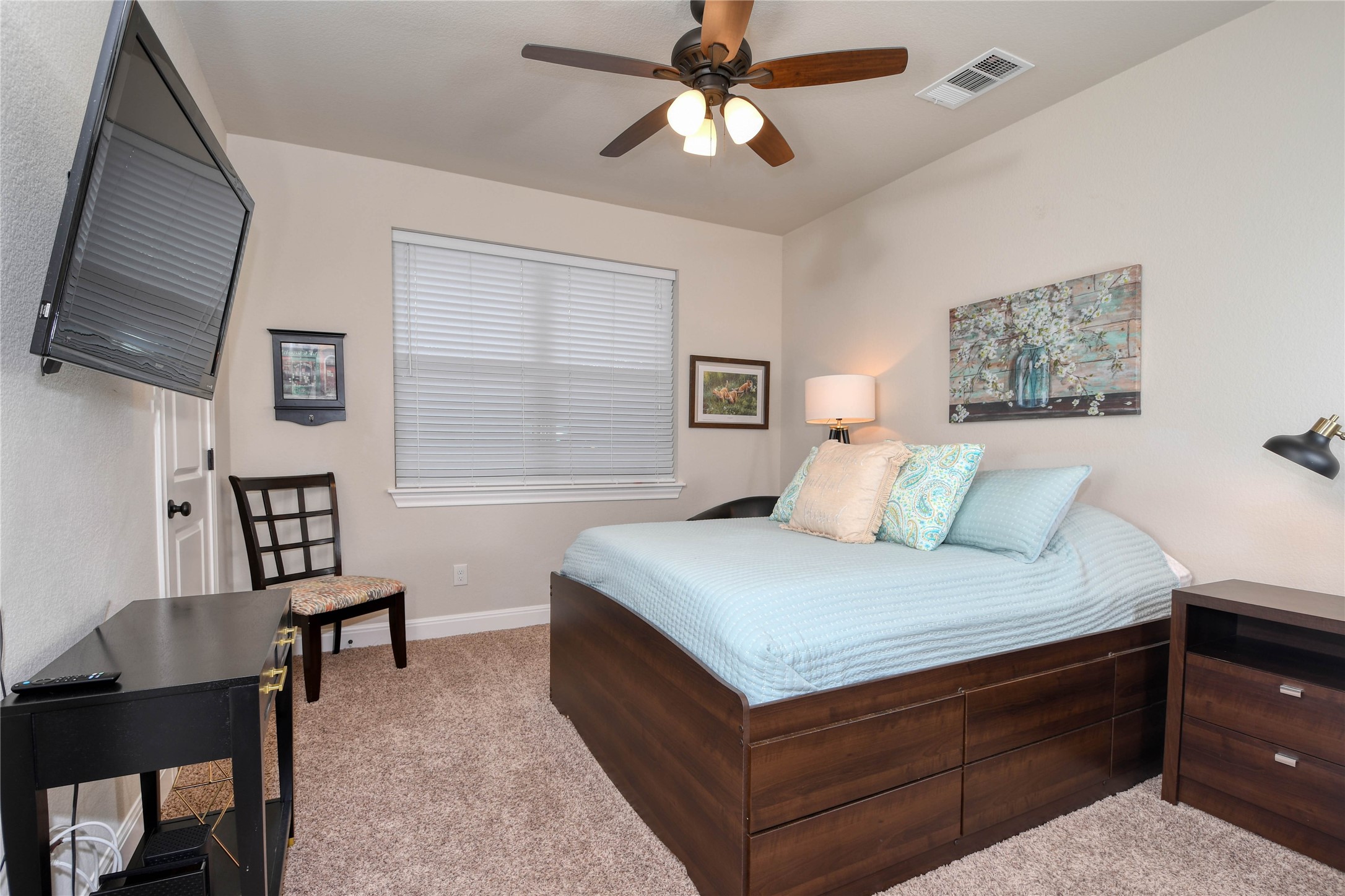 565 Demarett Drive Point Venture, TX 78645 - Photo 14 of 46 The 2nd bedroom is spacious with a view of the beautiful oaks.