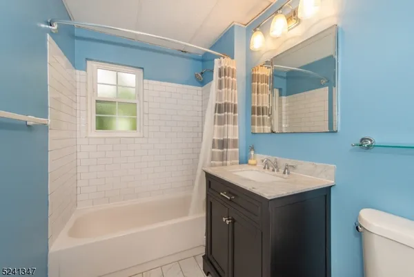 a bathroom with a sink mirror toilet and bathtub