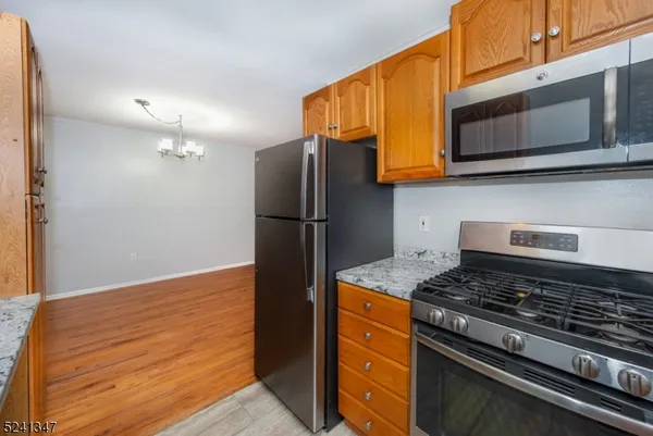 a kitchen with stainless steel appliances granite countertop a stove and a refrigerator