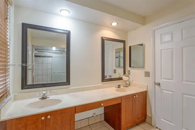 a bathroom with a sink double vanity and a mirror