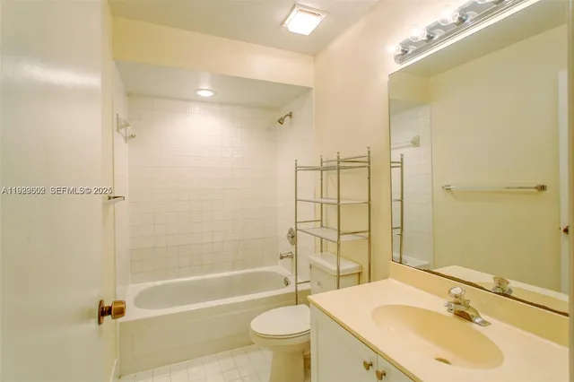 a bathroom with a sink toilet tub and shower