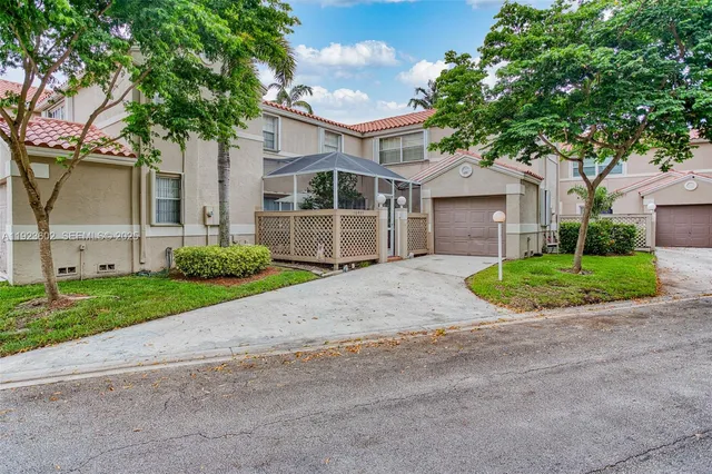 a front view of a house with a garden and trees