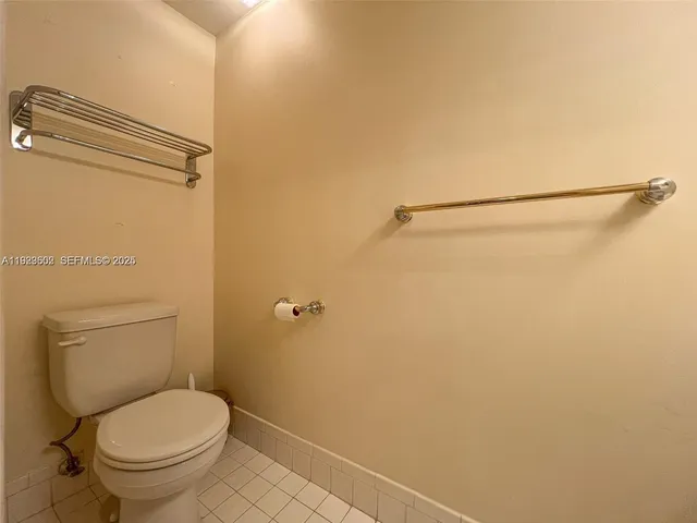 a white toilet sitting next to a shower
