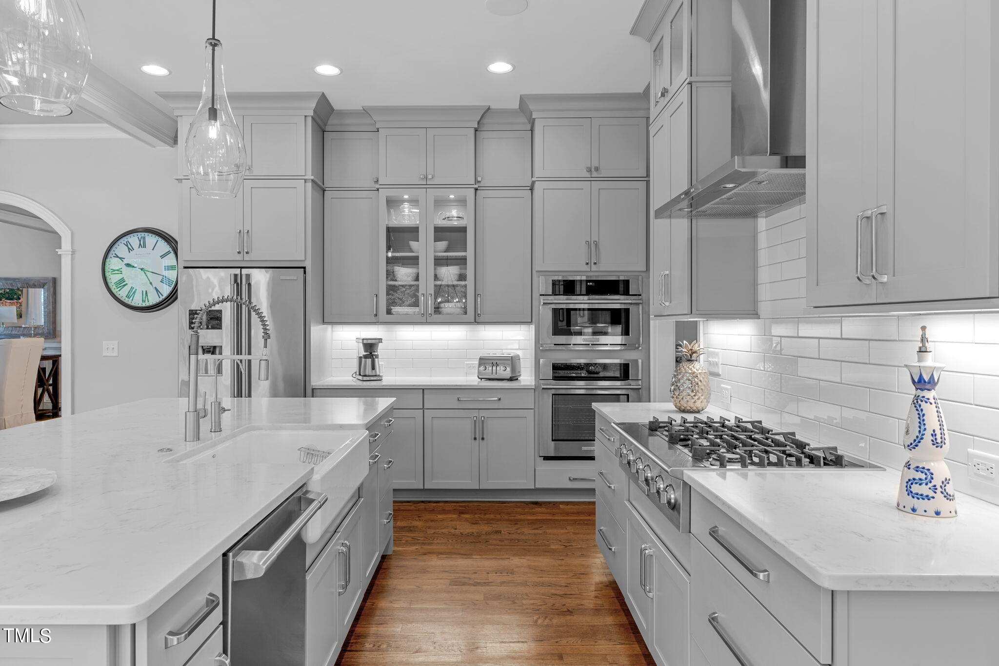 3130 Mantle Ridge Drive Apex, NC 27502 - Photo 19 of 81 a kitchen with a sink stainless steel appliances a counter space and cabinets