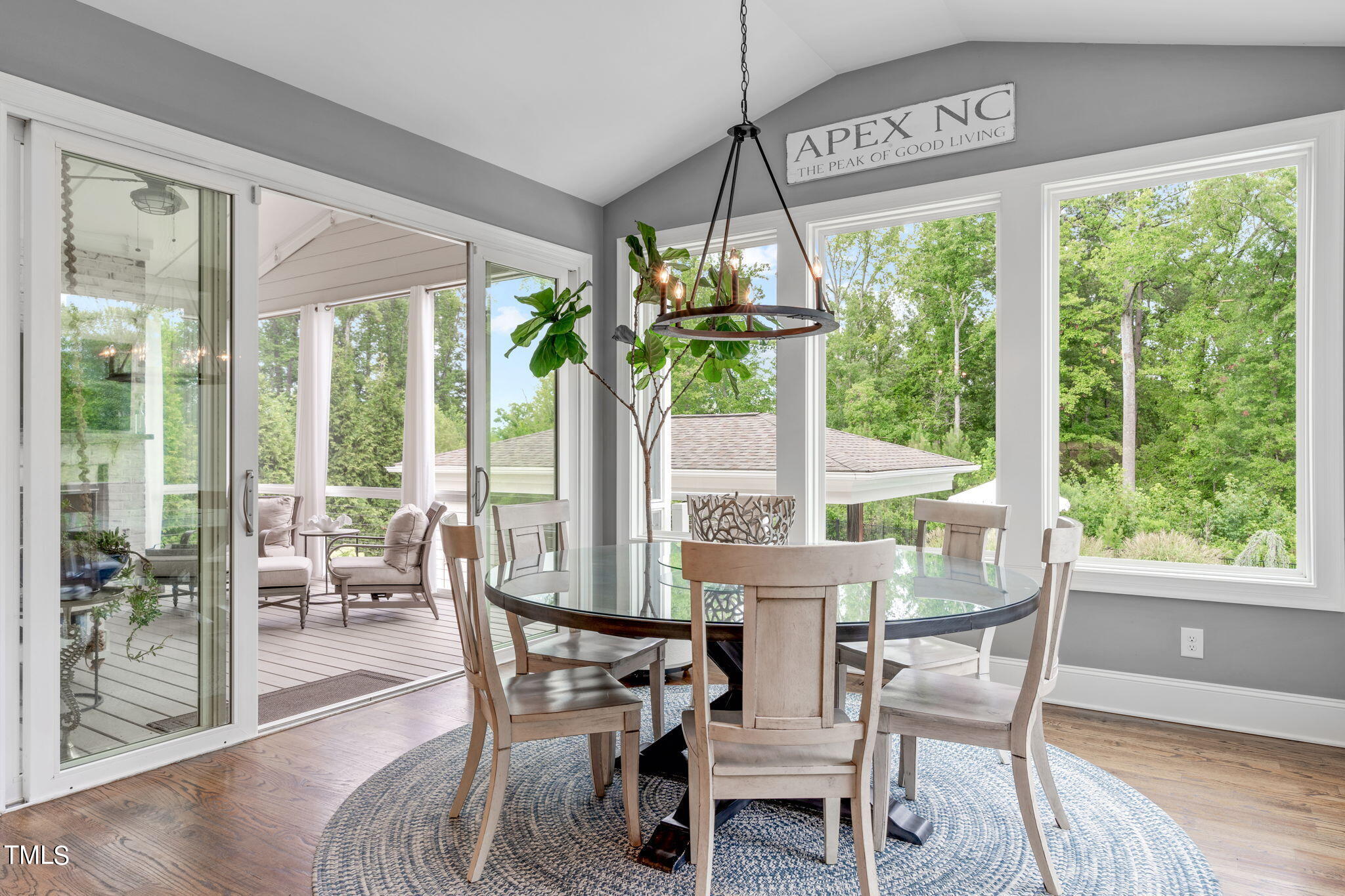 3130 Mantle Ridge Drive Apex, NC 27502 - Photo 24 of 81 a dining room with furniture water view and a floor to ceiling window