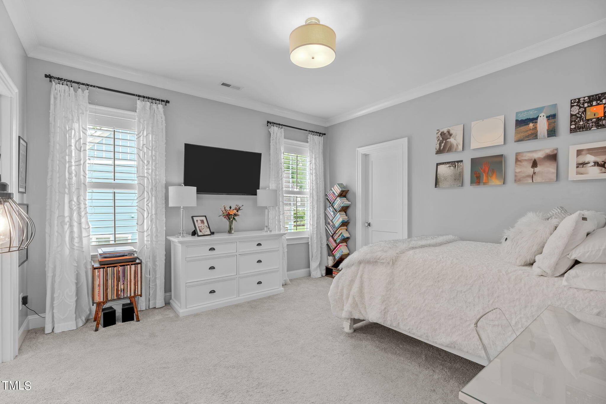 3130 Mantle Ridge Drive Apex, NC 27502 - Photo 36 of 81 a bedroom with a bed and a flat screen tv