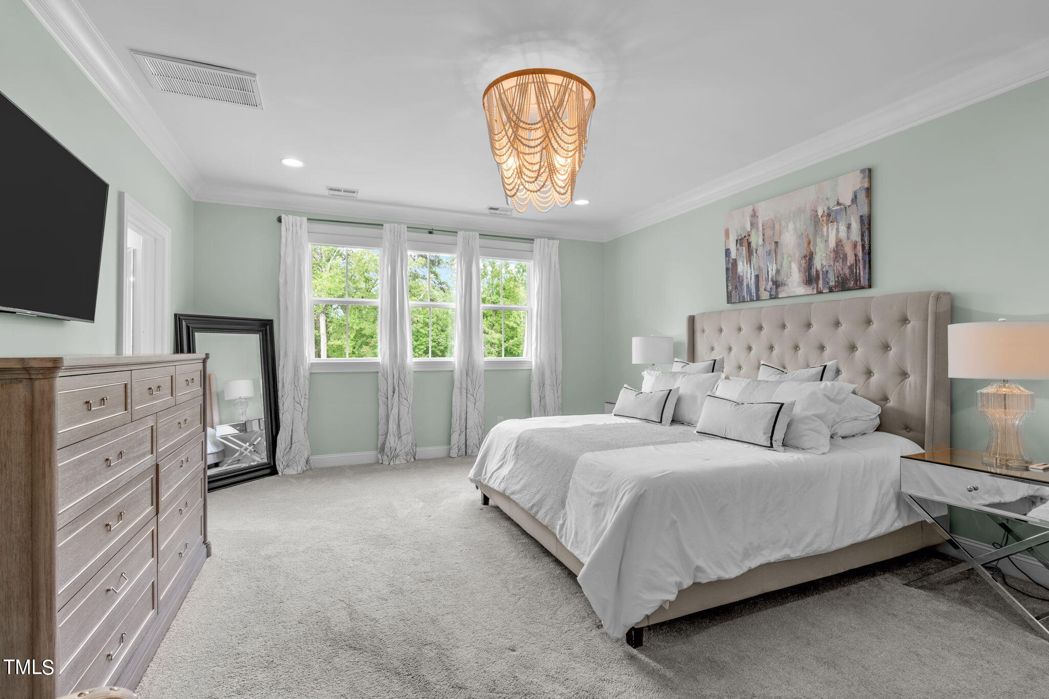 3130 Mantle Ridge Drive Apex, NC 27502 - Photo 42 of 81 a bedroom with a bed a flat screen tv and a large window