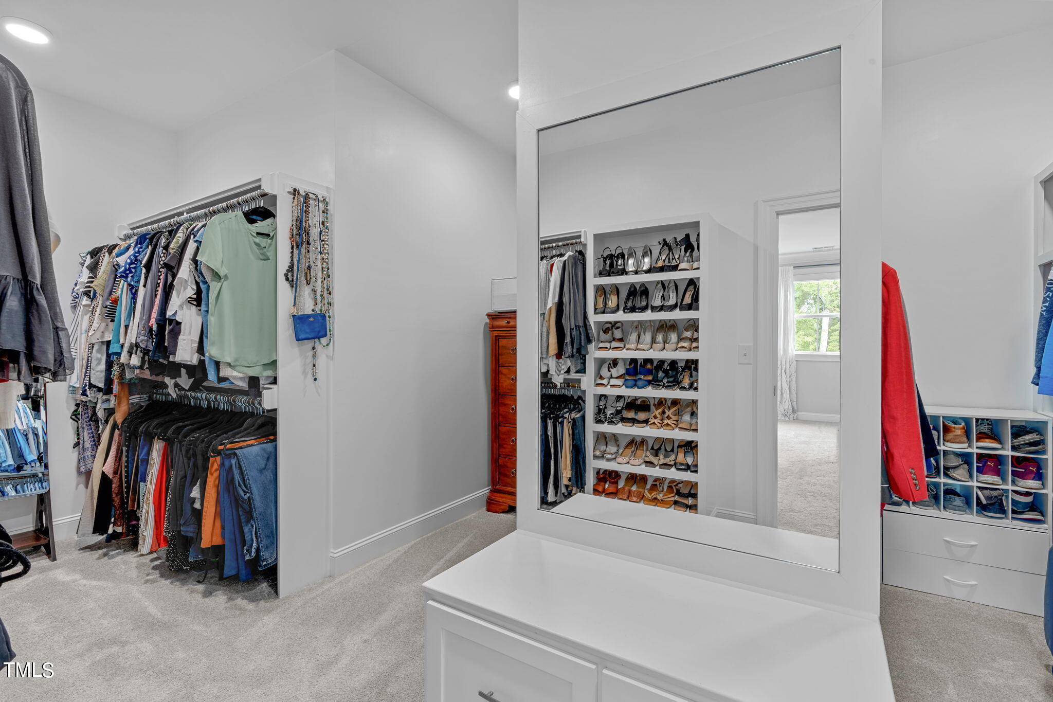 3130 Mantle Ridge Drive Apex, NC 27502 - Photo 43 of 81 a view of walk in closet with clothes and shoes