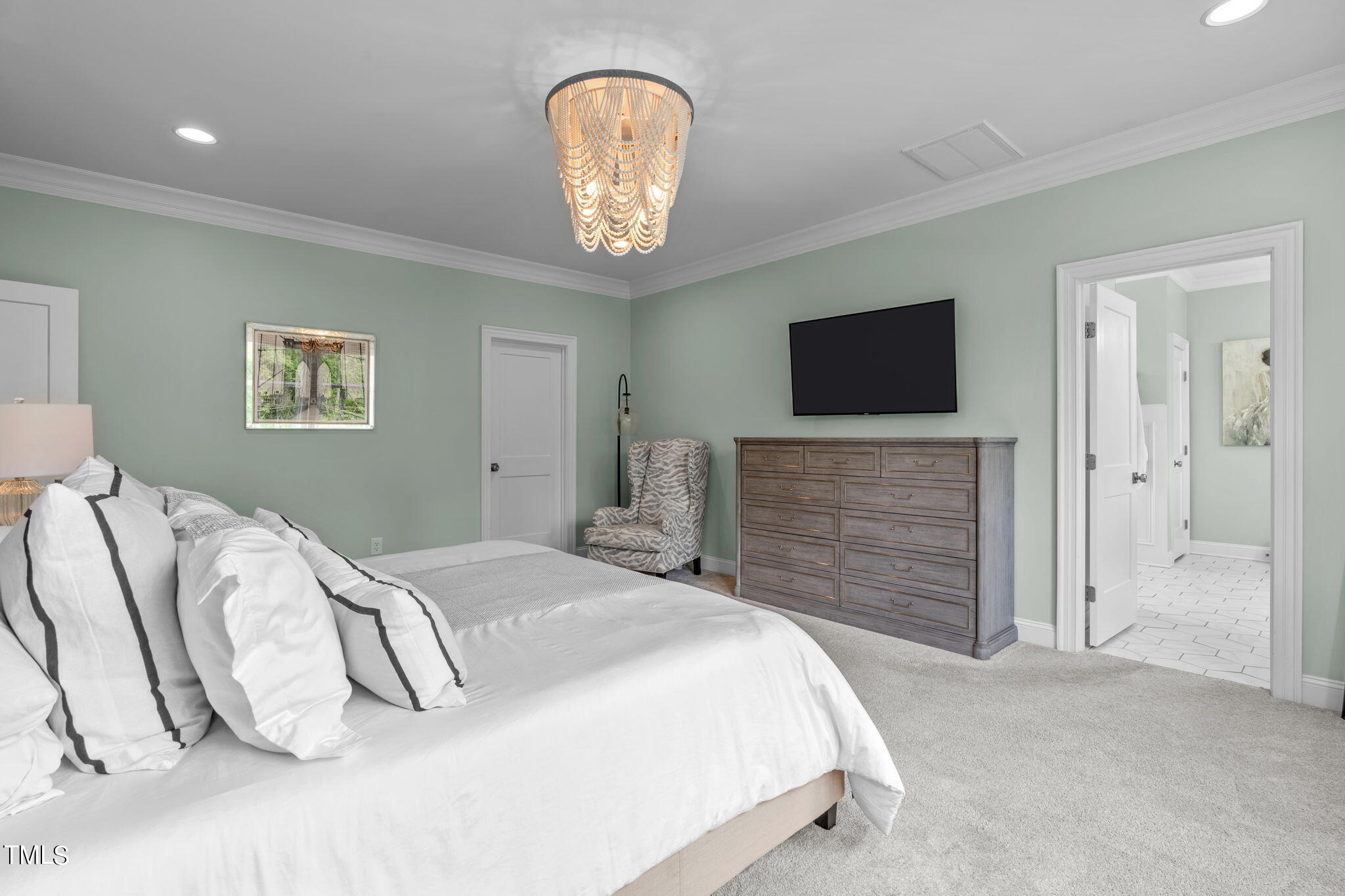 3130 Mantle Ridge Drive Apex, NC 27502 - Photo 45 of 81 a spacious bedroom with a bed and a flat screen tv