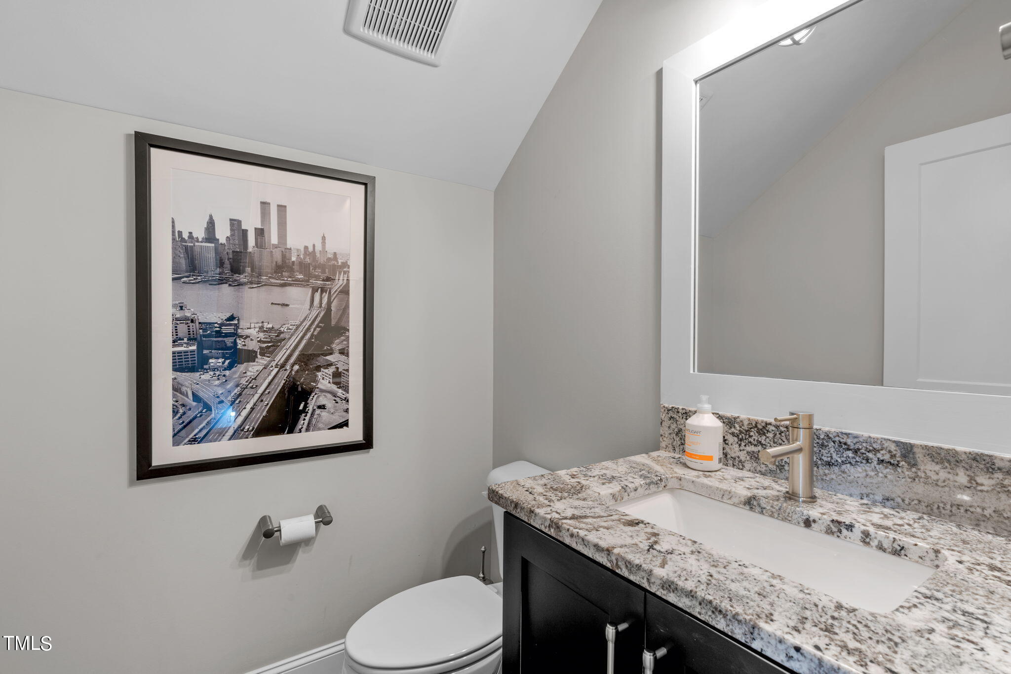 3130 Mantle Ridge Drive Apex, NC 27502 - Photo 52 of 81 a bathroom with a granite countertop toilet a sink and a mirror