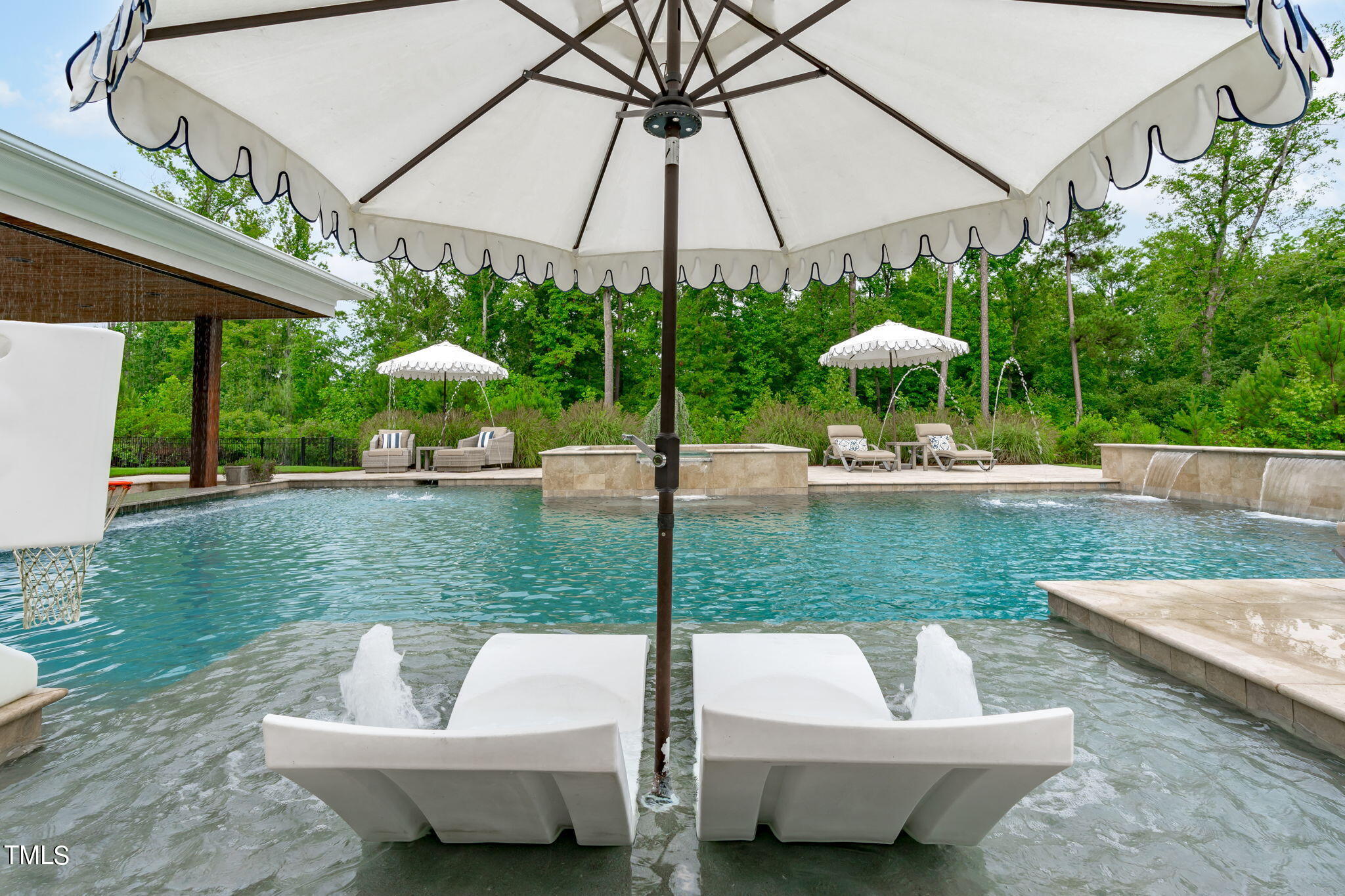 3130 Mantle Ridge Drive Apex, NC 27502 - Photo 66 of 81 a view of a patio with couches and table and chairs under an umbrella