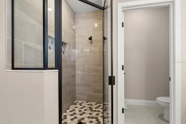 a bathroom with a granite countertop sink a toilet and a mirror