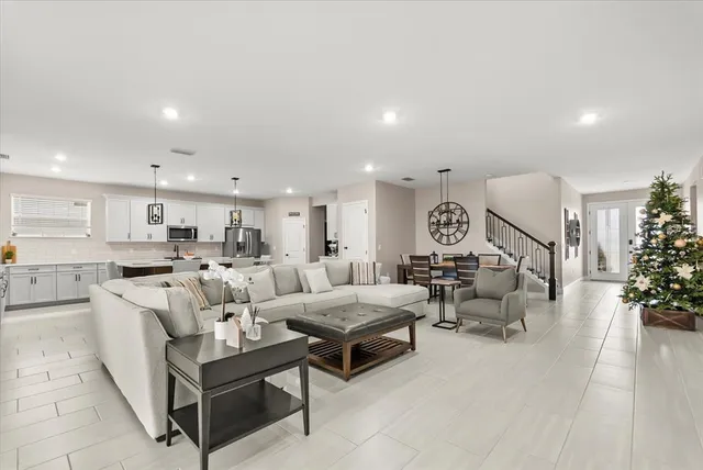 a living room with furniture and a large mirror