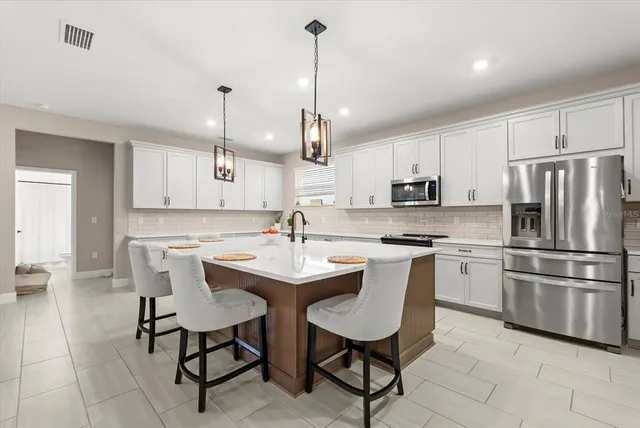 a living room with furniture a rug and a chandelier