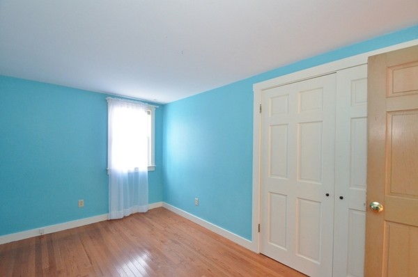 537 Fitchburg State Road Ashby, MA 01431 - Photo 10 of 17 an empty room with wooden floor and windows