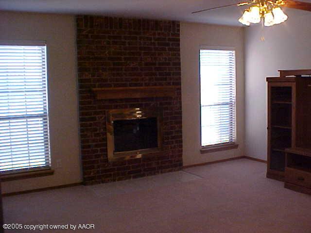 5204 Capulin Lane Amarillo, TX 79110 - Photo 3 of 10 a view of empty room with a fireplace