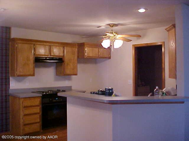 5204 Capulin Lane Amarillo, TX 79110 - Photo 4 of 10 a kitchen with a sink and a stove top oven
