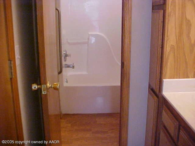 5204 Capulin Lane Amarillo, TX 79110 - Photo 8 of 10 a bathroom with a shower and a sink