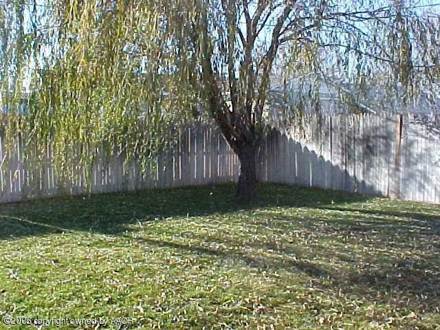 5204 Capulin Lane Amarillo, TX 79110 - Photo 10 of 10 a garden with trees in front of it