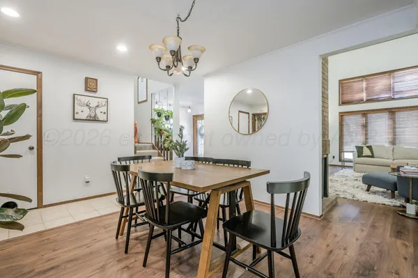 a view of a dining room with furniture wooden floor and chandelier