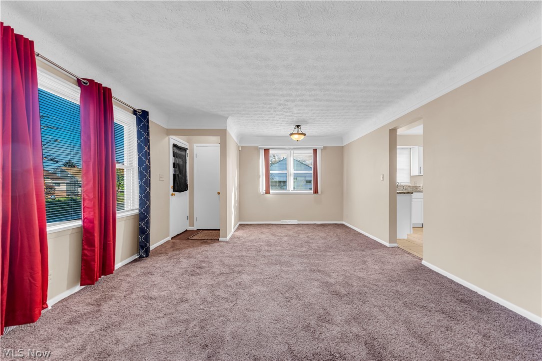 9716 Alexander Road Cleveland, OH 44125 - Photo 5 of 30 Empty room featuring a textured ceiling and light carpet