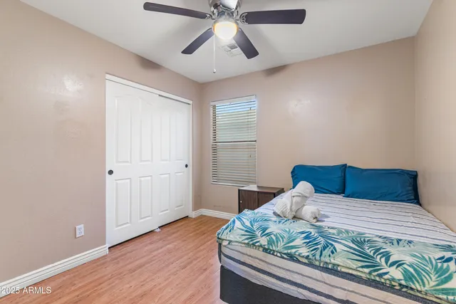 a bedroom with a bed and a chandelier