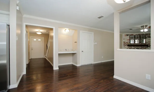 a view of a hallway with wooden floor