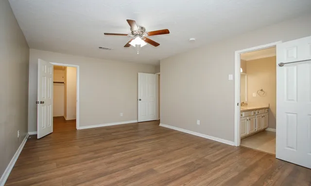 wooden floor in an empty room with a window