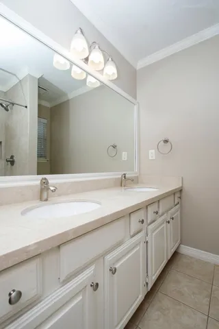 a bathroom with a double vanity sink and a mirror