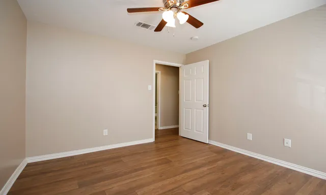 a view of an empty room and wooden floor