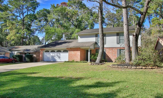 a view of a house with a yard and sitting area