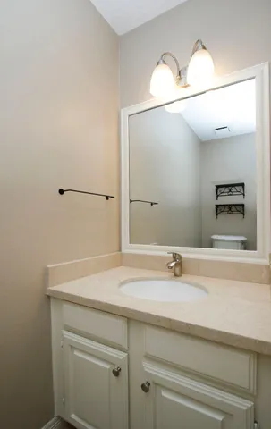 a view of a house with backyard and trees