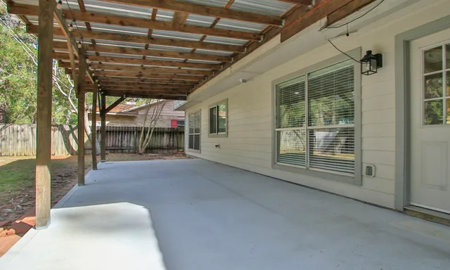 a backyard of a house with table and chairs