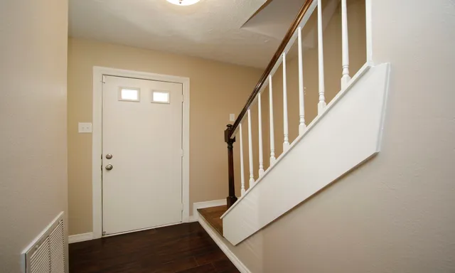 a view of an entryway with wooden floor