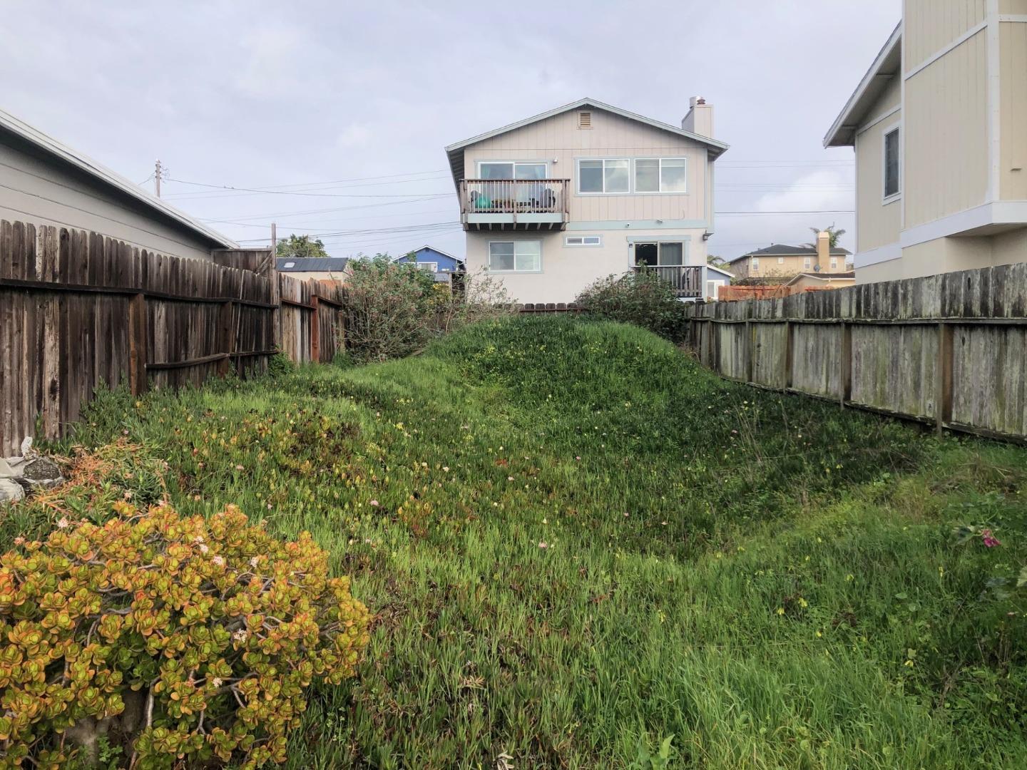 a view of a house with a yard and plants