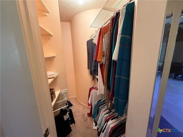 a view of a hallway with closet